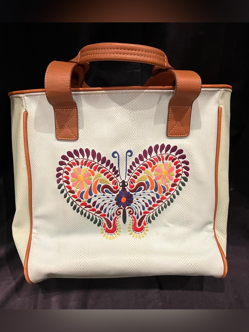 White Consuela Canvas Tote with Colorful Butterfly Embroidery and Tan Trim.